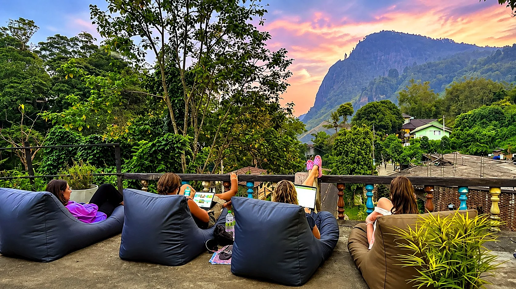 Guests watching the sunset from the terrace at Rock View Hostel Ella, with Ella Rock in the background