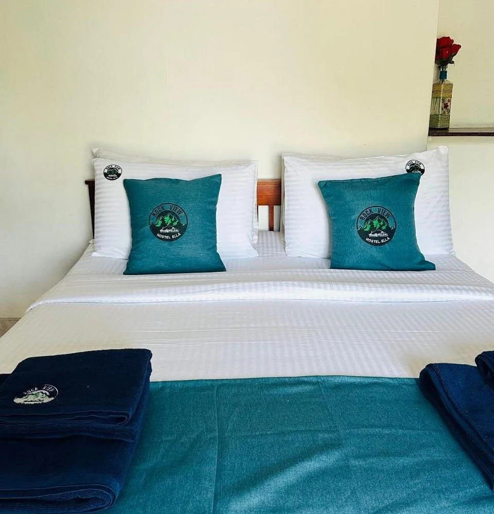 A guest room bed at Rock View Hostel Ella